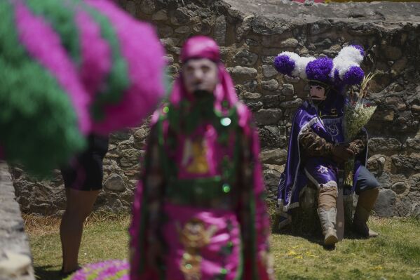 A reveler, known as a sayon, wears a tissue paper hat during an Easter celebration, in Tetela del Volcan, Mexico, Sunday, April 20, 2025. (AP Photo/Eduardo Verdugo)