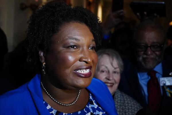 FILE - Georgia gubernatorial Democratic candidate Stacey Abrams talks to the media after qualifying for the 2022 election on Tuesday, March 8, 2022, in Atlanta.  Abrams has become a millionaire. A disclosure filed in March shows the candidate for governor is worth $3.17 million, thanks mostly to book and speaking income. Abrams was worth $109,000 in 2018 when she first ran for governor. (AP Photo/Brynn Anderson, File)