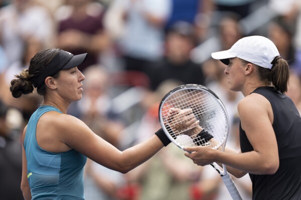 Jessica Pegula of the United States, left, shakes hands with Iga Swiatek of Poland, following the semifinals of the National Bank Open women’s tennis tournament Saturday, Aug. 12, 2023, in Montreal. (Christinne Muschi/The Canadian Press via AP)