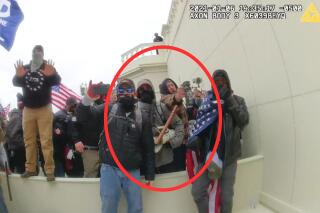 In this image from a Washington Metropolitan Police Department officer's body-worn video camera, released and annotated by the Justice Department in the Government's Sentencing Memorandum, Peter Schwartz circled in red is shown using a canister of pepper spray against officers on Jan. 6, 2021, in Washington. Schwartz on Friday, May 5, 2023, was sentenced to 14 years in prison for attacking police officers with pepper spray as he stormed the U.S. Capitol with his wife. (Justice Department via AP)