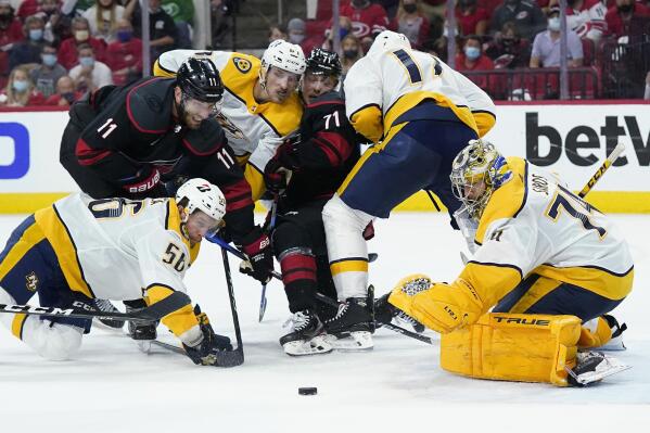 Carolina Hurricanes center Jordan Staal (11) and right wing Jesper Fast (71) struggle for the puck against Nashville Predators goaltender Juuse Saros (74) while Predators left wing Erik Haula (56), left wing Tanner Jeannot and defenseman Ben Harpur (17) defend during the second period in Game 5 of an NHL hockey Stanley Cup first-round playoff series in Raleigh, N.C., Tuesday, May 25, 2021. (AP Photo/Gerry Broome)