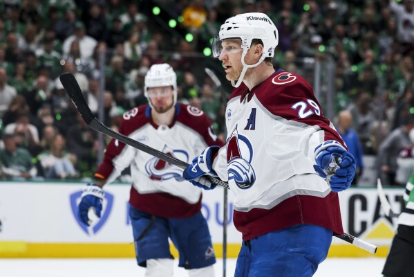 Colorado Avalanche center Nathan MacKinnon (29) celebrates after scoring a power-play goal during a first-round NHL hockey playoff game against the Dallas Stars in Dallas, Saturday, April 19, 2025. (AP Photo/Gareth Patterson)