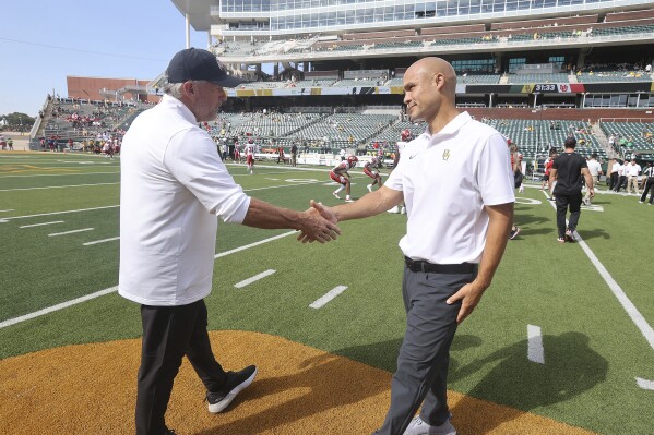 Utah head coach Kyle Whittingham, left, and Baylor head coach Dave Aranda greet each other before an NCAA college football game, Saturday, Sept. 9, 2023, in Waco, Texas. (AP Photo/Jerry Larson)