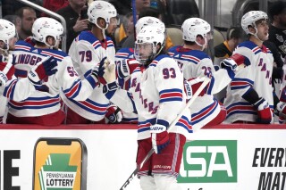 New York Rangers' Mika Zibanejad returns to his bench after scoring during the second period of an NHL hockey game against the Pittsburgh Penguins in Pittsburgh, Saturday, March 16, 2024. The Rangers won 7-4(AP Photo/Gene J. Puskar)