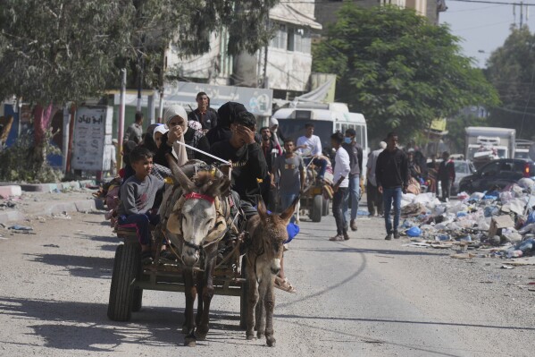 Palestinians flee from northern Gaza to the south after the Israeli army issued an unprecedented evacuation warning to a population of over 1 million people in northern Gaza, Friday, Oct. 13, 2023. (AP Photo/Hatem Moussa)