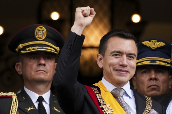 Newly sworn-in President Daniel Noboa waves from a balcony of the Carondelet presidential palace in Quito, Ecuador, Thursday, Nov. 23, 2023. (AP Photo/Carlos Noriega)