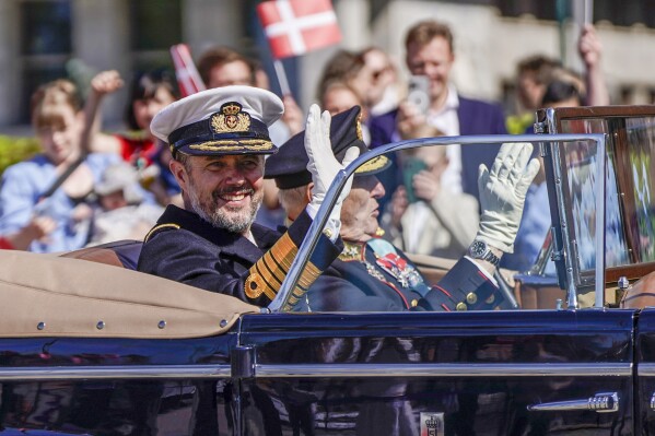 King Frederik of Denmark, left, and Norway's King Harald wave as they sit in a car during King Frederik's official state visit to Norway, in Oslo Tuesday, May 14, 2024. (Håkon Mosvold Larsen/NTB Scanpix via AP)