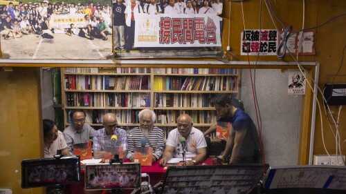 "The Bull" Tsang Kin-shing, right, founder of Hong Kong's pro-democracy Citizens' Radio station, along with guests, hold their last broadcast in Hong Kong, Friday, June 30, 2023. (AP Photo/Louise Delmotte)