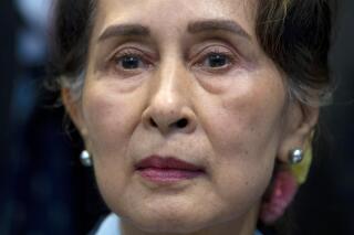 FILE - Myanmar's lthen eader Aung San Suu Kyi waits to address judges of the International Court of Justice on the second day of three days of hearings in The Hague, Netherlands, Dec. 11, 2019. Myanmar convicted ousted leader Aung San Suu Kyi on two more corruption counts on Wednesday, Oct. 12, 2022, extending her total prison term to 26 years. (AP Photo/Peter Dejong, File)