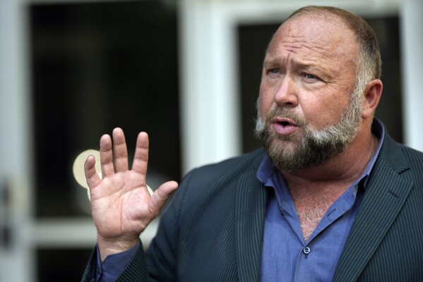 Right-wing conspiracy theorist Alex Jones speaks outside the federal courthouse after a bankruptcy hearing Friday, June 14, 2024, in Houston. (AP Photo/David J. Phillip)