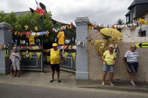 Spectators stand along the road during the fourteenth stage of the Tour de France cycling race over 117,5 kilometers (73 miles) with start in Tarbes and finish at the Tourmalet pass, France, Saturday, July 20, 2019. (AP Photo/ Christophe Ena)