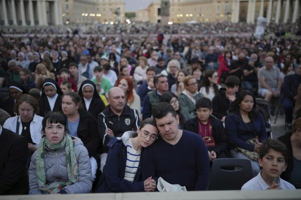 Faithful gather for a rosary prayer for the late Pope Francis, in St. Peter's Square at the Vatican, Monday April 21, 2025. (AP Photo/Alessandra Tarantino)