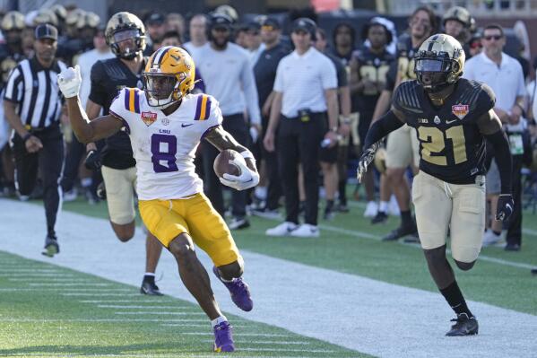 LSU wide receiver Malik Nabers (8) runs past Purdue cornerback Bryce Hampton, left, and safety Sanoussi Kane (21) on his way to a 75-yard touchdown on a pass play during the second half of the Citrus Bowl NCAA college football game Monday, Jan. 2, 2023, in Orlando, Fla. (AP Photo/John Raoux)