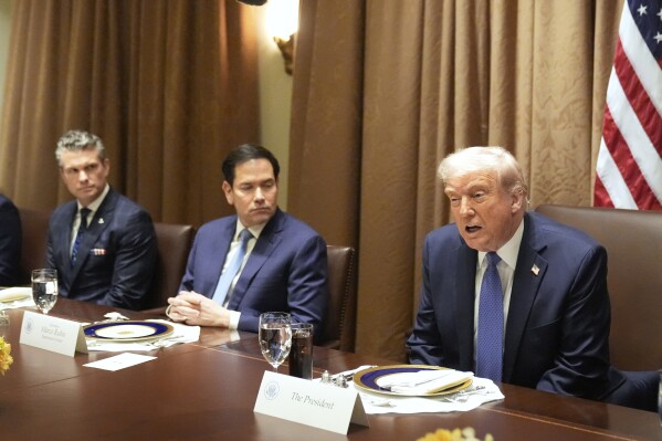 President Donald Trump speaks as Secretary of State Marco Rubio and Secretary of Defense Pete Hegseth listen in the Cabinet Room of the White House, April 24, 2025. (AP Photo/Mark Schiefelbein, File)