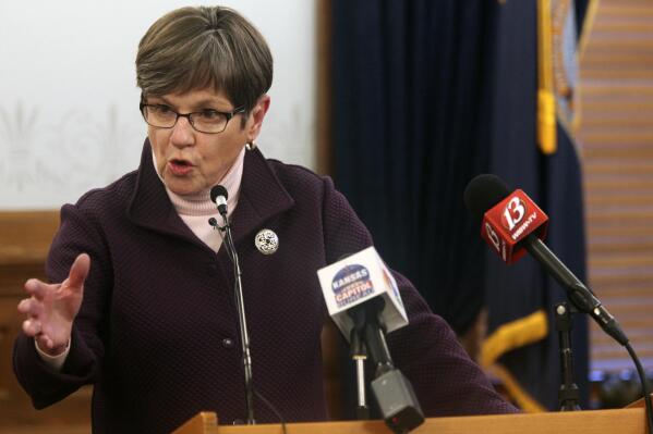 Kansas Gov. Laura Kelly answers questions during a news conference, Wednesday, Feb. 3, 2021, at the Statehouse in Topeka, Kan. The Democratic governor is facing increasingly vocal criticism from the Republican-controlled Legislature over problems at the state Department of Labor, that include a flood of fraudulent claims for unemployment benefits. (AP Photo/John Hanna)