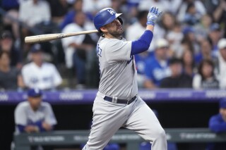 FILE - Los Angeles Dodgers' J.D. Martinez watches his two-run home run off Colorado Rockies starting pitcher Chris Flexen during the first inning of a baseball game Sept. 28, 2023, in Denver. Martinez has a new home, agreeing to a $12 million, one-year contract with the New York Mets on Thursday, March 21, according to a person familiar with the deal. The person spoke to The Associated Press on condition of anonymity because the agreement was pending a physical. (AP Photo/David Zalubowski, File)