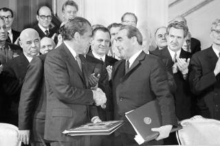 U.S. President Richard Nixon and Communist Party leader Leonid Brezhnev shake hands after signing the Strategic Arms Limitation agreement in the Kremlin, May 26, 1972. Politburo member Dmitry Polyansky is at center. (AP Photo)