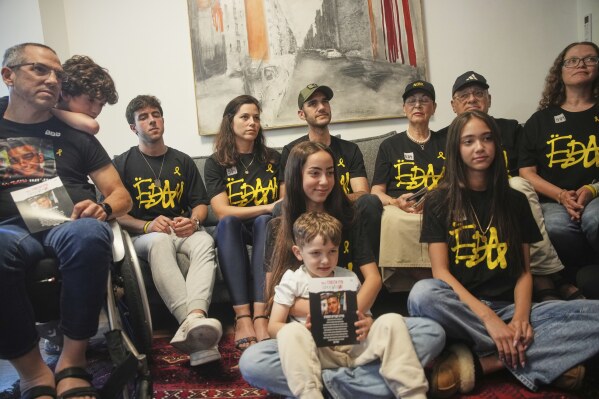 Relatives and friends of Israeli-American soldier Edan Alexander gather to watch the TV broadcast of his release from Hamas captivity in Gaza, in Tel Aviv, Monday, May 12, 2025. Alexander was abducted during the Hamas-led attack on his base on October 7, 2023. (AP Photo/Ohad Zwigenberg)