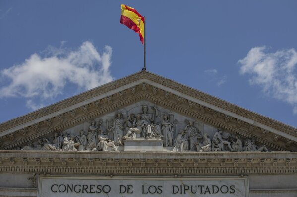 
              The Spanish flag flutters atop of the Spanish parliament in Madrid, Spain, Friday, May 24, 2019. The lower chamber of Spain's Parliament has suspended four Catalan separatist politicians from their recently gained positions as national lawmakers because they are currently in jail during an ongoing trial for rebellion and other charges.(AP Photo/Bernat Armangue)
            