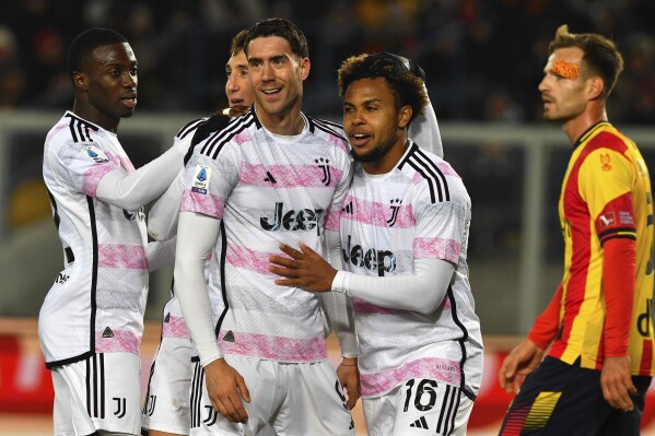 Juventus' players Dusan Vlahovic, center left, and Weston McKennie, right, celebrate the team's goal during the Italian Serie A soccer match between Lecce and Juventus at the Via del Mare Stadium in Lecce, Italy, Sunday, Jan. 21, 2024. (Giovanni Evangelista/LaPresse via AP)