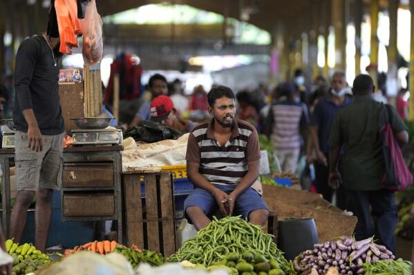FILE - A vender waits for customers at a vegetable market place in Colombo, Sri Lanka, Friday, June 10, 2022. China’s government on Friday, Feb. 3, 2023, confirmed it is offering Sri Lanka a two-year moratorium on loan repayment as the Indian Ocean island nation struggles to restructure $51 billion in foreign debt that pushed it into a financial crisis. (AP Photo/Eranga Jayawardena)