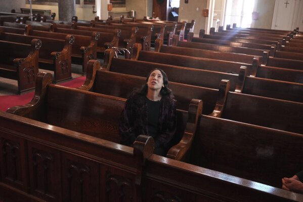 Art conservator Naomi Ruiz looks at murals by Croatian-American artist Maxo Vanka in St. Nicholas Croatian Catholic Church in Millvale, Pa., Jan. 21, 2025. (AP Photo/Gene J. Puskar
