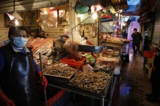 FILE - Vendors wait for clients at the La Nueva Viga seafood market, part of the Central de Abastos, the capital's main market, in Mexico City, Dec. 9, 2020. Mexico closed 2021 with inflation of 7.36%, the highest rate in two decades, fueling concern among analysts that the rate of price growth will continue in the coming months, which could put pressure on the Bank of Mexico to make further adjustments in interest rates. (AP Photo/Rebecca Blackwell, File)