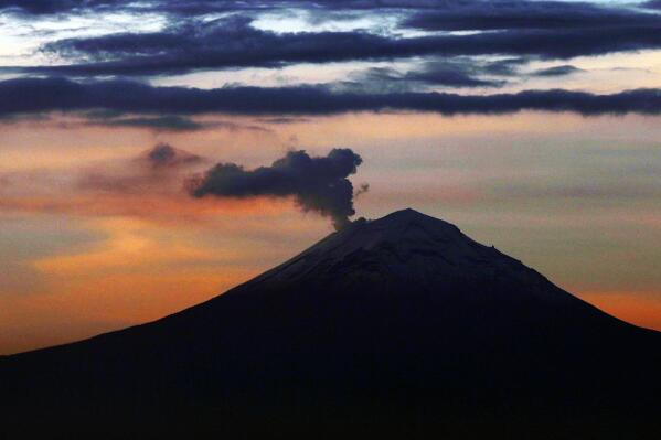 FILE - A plume of ash and steam rises from the Popocatepetl volcano, as seen from Mexico City, Wednesday, June 19, 2019. Popocatepetl rumbled to life again this third week of May 2023, spewing out towering clouds of ash that forced 11 villages to cancel school sessions. (AP Photo/Marco Ugarte, File)