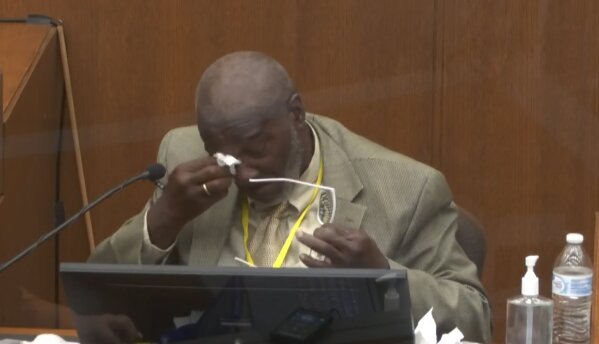 In this image from video, witness Charles McMillian becomes emotional as he answers questions as Hennepin County Judge Peter Cahill presides Wednesday, March 31, 2021, in the trial of former Minneapolis police Officer Derek Chauvin at the Hennepin County Courthouse in Minneapolis, Minn.  Chauvin is charged in the May 25, 2020 death of George Floyd.  (Court TV via AP, Pool)