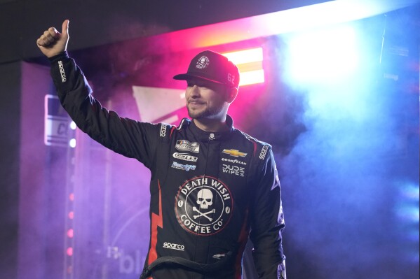 Anthony Alfredo waves to fans during driver introductions before the two Daytona 500 qualifying auto races at Daytona International Speedway, Thursday, Feb. 15, 2024, in Daytona Beach, Fla. (AP Photo/John Raoux)