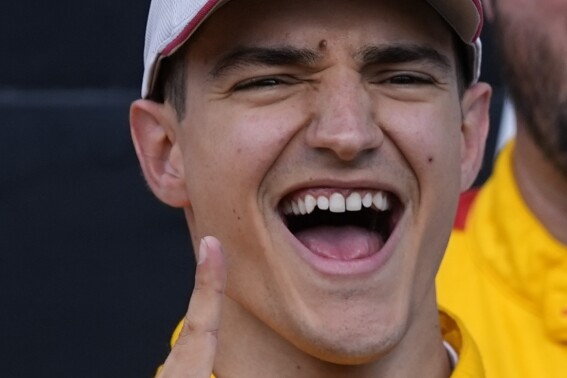 Alex Palou, of Spain, celebrates after winning the IndyCar Grand Prix auto race at Indianapolis Motor Speedway, Saturday, May 11, 2024, in Indianapolis. (AP Photo/Darron Cummings)