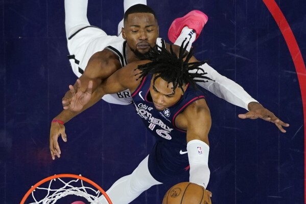 Philadelphia 76ers' Ricky Council IV, bottom, goes up for a shot against Brooklyn Nets' Harry Giles III during the second half of an NBA basketball game, Saturday, Feb. 3, 2024, in Philadelphia. (AP Photo/Matt Slocum)