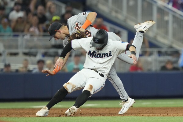 Detroit Tigers second baseman Zack Short (59) collides with Miami Marlins' Jon Berti (5) during the sixth inning of a baseball game, Sunday, July 30, 2023, in Miami. (AP Photo/Marta Lavandier)