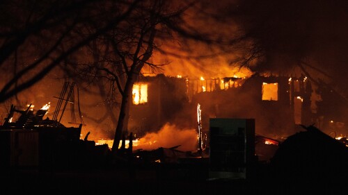 FILE - The Marshall Fire engulfs a home in Louisville, Colo., Dec. 30, 2021, as crews worked through the night battling the blaze that had destroyed more than 500 home in Boulder County. On Thursday, July 6, 2023, dozens of insurance companies filed suit against Minneapolis-based Xcel Energy to recoup money paid out to homes and businesses lost in Colorado's Marshall Fire, the state's most destructive wildfire in 2021. (Christian Murdock/The Gazette via AP, File)