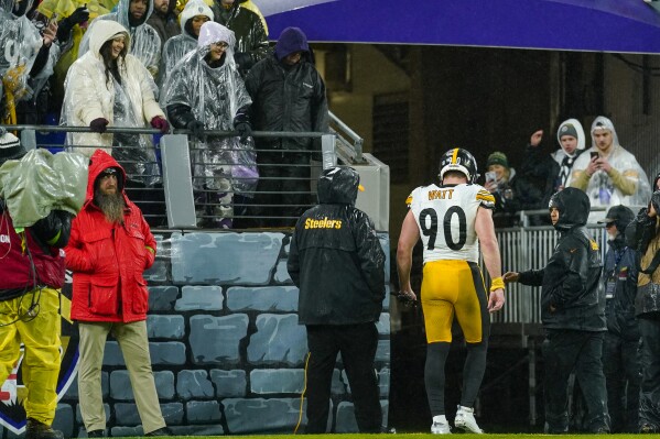 Pittsburgh Steelers linebacker T.J. Watt walks with medical staff to the lockers during the second half of an NFL football game against the Baltimore Ravens, Saturday, Jan. 6, 2024 in Baltimore. (AP Photo/Matt Rourke)