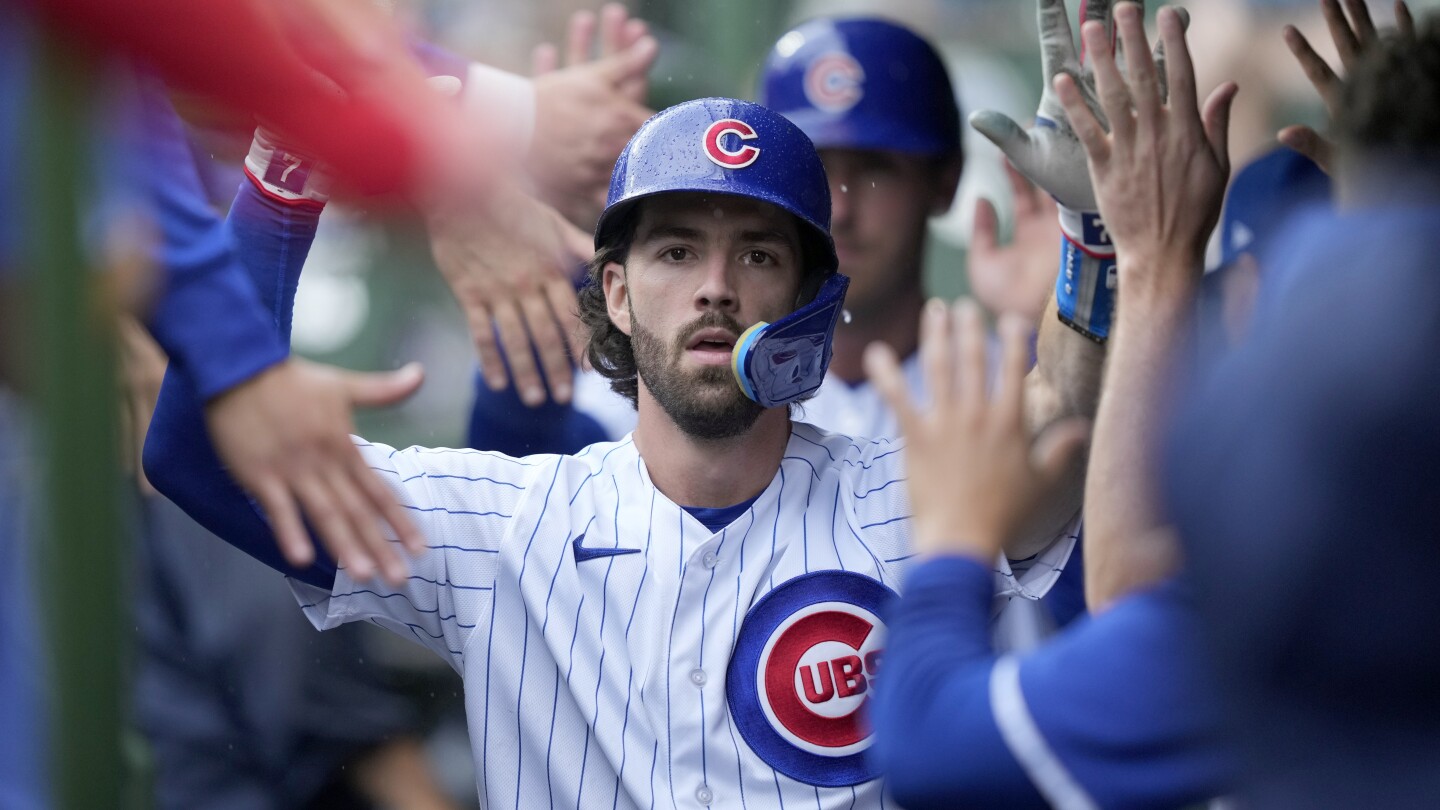 Chicago Cubs' Cody Bellinger greets Dansby Swanson at home after