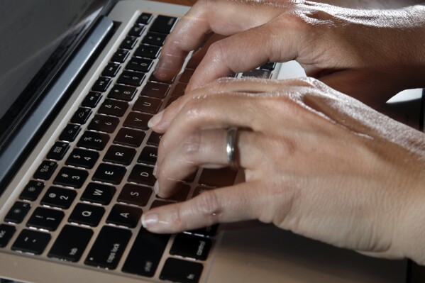 FILE - A person types on a laptop keyboard, Monday, June 19, 2017, in North Andover, Mass. The leader of struggling telemedicine provider Teladoc Health has left, effective immediately, the company announced Friday, April 5, 2024. Teladoc gave no reason for the departure of CEO Jason Gorevic. (AP Photo/Elise Amendola, File)