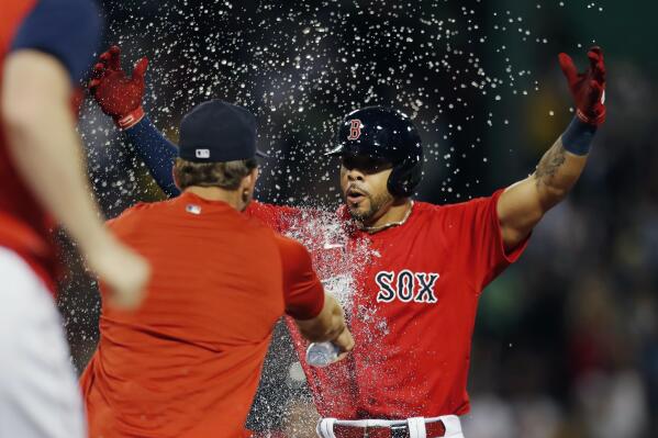 Boston Red Sox's Tommy Pham, right, celebrates after hitting a walkoff RBI-single during the 10th inning of a baseball game against the New York Yankees, Friday, Aug. 12, 2022, in Boston. (AP Photo/Michael Dwyer)