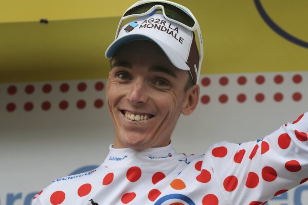 France's Romain Bardet wearing the best climber's dotted jersey celebrates on the podium after the twentieth stage of the Tour de France cycling race over 59,5 kilometers (36,97 miles) with start in Albertville and finish in Val Thorens, France, Saturday, July 27, 2019. (AP Photo/Thibault Camus)