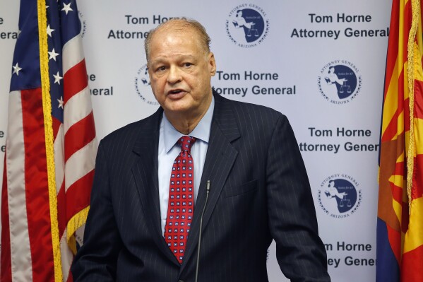 FILE - Then-Arizona Attorney General Tom Horne talks to the media, Oct. 17, 2014, in Phoenix. On Tuesday, March 5, 2024, a Maricopa County Superior Court judge dismissed a lawsuit by Horne, now Arizona's superintendent of public instruction, challenging programs that some school districts use to teach non-English speaking students. Horne said he will appeal the ruling. (AP Photo/Rick Scuteri, File)