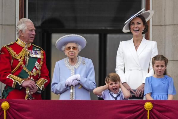 Prince Charles, from left, Queen Elizabeth II, Prince Louis, Kate, Duchess of Cambridge, Princess Charlotte on the balcony of Buckingham Palace, London, Thursday June 2, 2022, on the first of four days of celebrations to mark the Platinum Jubilee. (Alastair Grant/Pool Photo via AP)