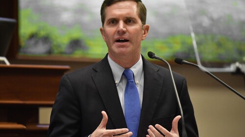 FILE - Kentucky Gov. Andy Beshear delivers his State of the Commonwealth speech in front of a joint session of the legislature from the floor of the Kentucky House of Representatives, Jan. 4, 2023, in Frankfort, Ky. Overall serious crime rates fell across Kentucky in 2022, with double-digit declines in reports of homicides, robberies and drug offenses, a new crime report showed Wednesday, July 19, 2023. Beshear said that the report is 