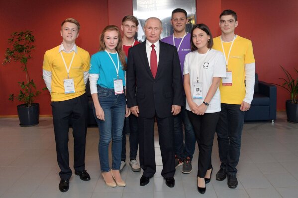 
              Russian President Vladimir Putin, center, poses for a group picture with students in Yaroslavl, Russia, Friday, Sept. 1, 2017. Putin said that whoever reaches a breakthrough in developing artificial intelligence will come to dominate the world. Putin, speaking Friday at a meeting with students, said the development of AI raises "colossal opportunities and threats that are difficult to predict now." (Alexei Druzhinin, Kremlin Pool Photo via AP)
            