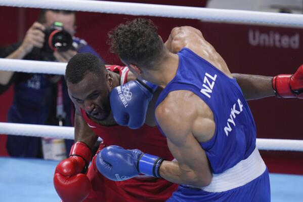 New Zealand's David Nyika, right, lands a punch to Youness Baalla, of Morocco, during their heavy weight (91kg) preliminary boxing match at the 2020 Summer Olympics, Tuesday, July 27, 2021, in Tokyo, Japan. (AP Photo/ Frank Franklin II)