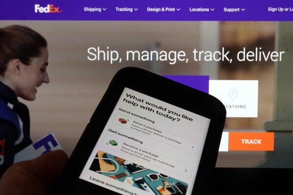 A FedEx webpage and the Uber package app page are shown in this photo, in New York, Wednesday, Oct. 4, 2023. Uber, the ride-hailing and delivery company, said Wednesday that it is adding a new task to its list of services: mailing consumers' return packages. (AP Photo/Richard Drew)