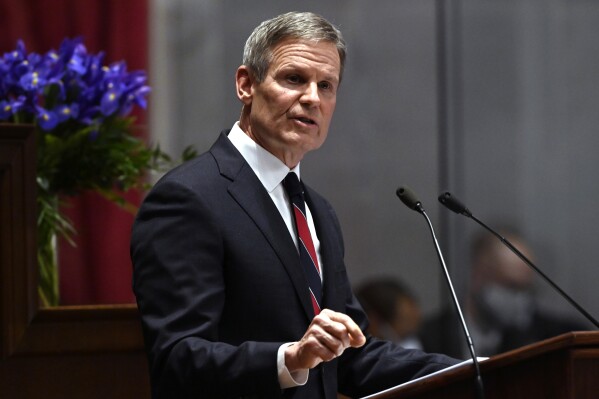 FILE - Tennessee Gov. Bill Lee delivers his State of the State address in the House Chamber of the Capitol building, Jan. 31, 2022, in Nashville, Tenn. A professional organization that advocates for Tennessee teachers has filed a lawsuit challenging a new state law that bans the group from deducting membership dues from educators' paychecks. The Tennessee Education Association filed the challenge Monday, June 12, 2023 over the two-pronged law, which also gradually raises the minimum teacher salary up to $50,000 for the 2026-2027 school year. The association supports the pay raise, but opposes the deductions ban. Gov. Lee pushed for the dual-purpose bill with the support from the GOP-dominant General Assembly this year. (AP Photo/Mark Zaleski, file)
