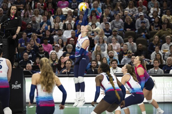 Omaha Supernovas' Jess Schaben-Lansman, center, hits the ball over the net against Atlanta Vibe during a Pro Volleyball Federation game Wednesday, Jan. 24, 2024, in Omaha, Neb. (AP Photo/Rebecca S. Gratz)