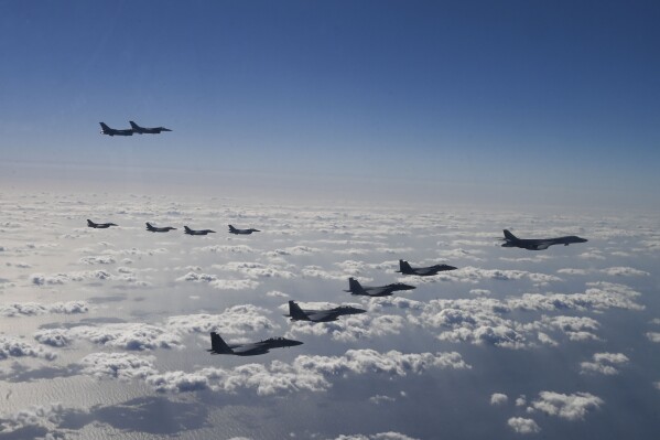 In this photo provided by the U.S. Air Force via South Korea Defense Ministry, U.S. Air Force B-1B bombers, F-16 fighter jets, South Korean Air Force F-15K fighter jets and Japanese Air Force F-2 fighter jets fly during a trilateral air drill at an undisclosed location, Sunday, Nov. 3, 2024. (U.S. Air Force/South Korea Defense Ministry via AP)