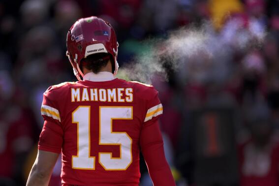 Steam from Kansas City Chiefs quarterback Patrick Mahomes' breath is seen during the first half of an NFL football game against the Seattle Seahawks Saturday, Dec. 24, 2022, in Kansas City, Mo. (AP Photo/Charlie Riedel)