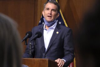 Virginia Gov. Ralph Northam answers a reporter's question during a press briefing inside the Patrick Henry Building in Richmond, Va., Tuesday, Sept. 15, 2020. (Bob Brown/Richmond Times-Dispatch via AP)